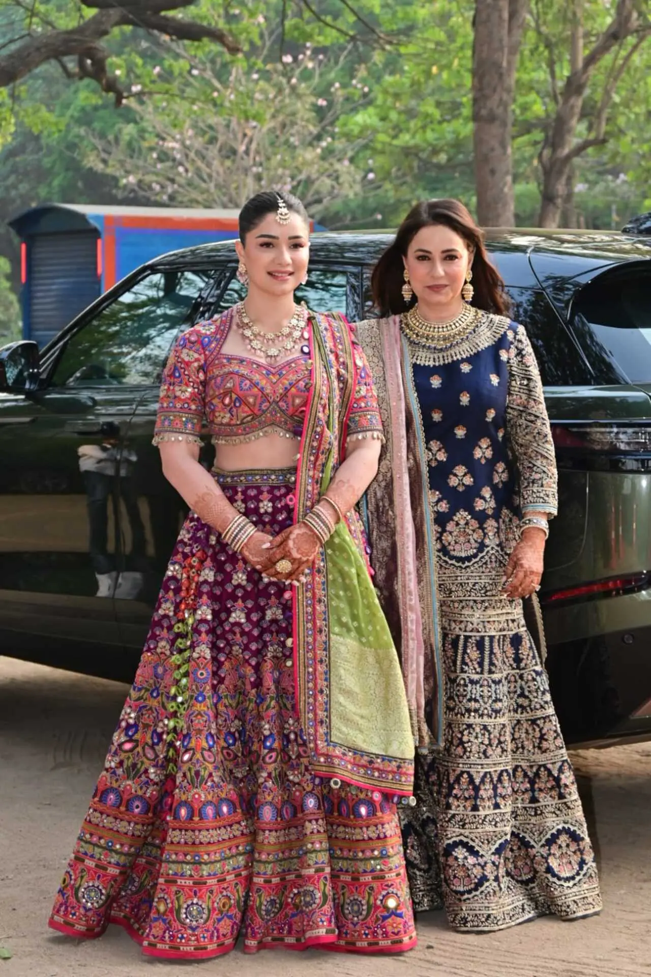 Sara Tendulkar and Anjali Tendulkar looked elegant at the mehendi ceremony, embracing vibrant ethnic styles. Sara stunned in a heavily embroidered, multicoloured lehenga paired with statement jewellery and intricate mehendi, while Anjali complemented her in a navy blue embellished ensemble with regal gold detailing.